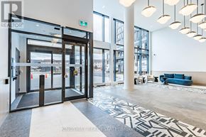 Burlington (Alton) condo for rent - A large glass door with a metal frame is the entrance to a building.