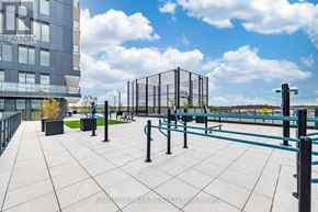 Burlington (Alton) condo for rent - A playground with a blue fence and a building in the background.