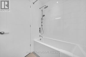 Toronto (University) condo for rent - A white bathroom with a tub and shower.