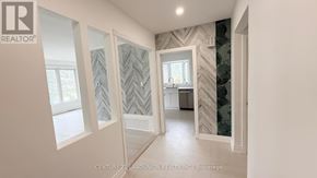 Richmond Hill (Crosby) apartment for rent - A hallway with a chevron patterned wallpaper and a window.