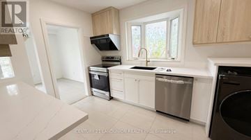 Richmond Hill (Crosby) apartment for rent - A kitchen with a white counter top and stainless steel appliances.
