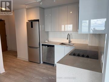 Vaughan (Vaughan Corporate Centre) condo for rent - A kitchen with a stainless steel refrigerator and dishwasher.