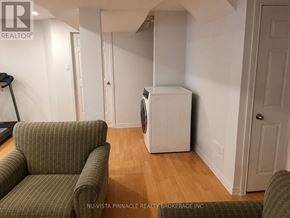 London South (South U) apartment for rent - A room with a green couch and a white refrigerator.