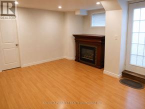 London South (South U) apartment for rent - A room with a fireplace and wooden floors.