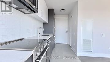 Toronto (Forest Hill North) condo for rent - A kitchen with a stainless steel oven and microwave above it.