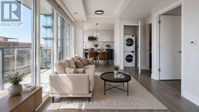 Toronto (Forest Hill North) condo for rent - A living room with a couch, a coffee table, and a potted plant.