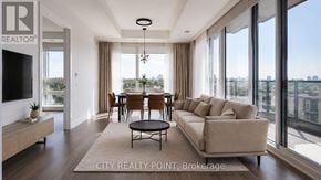 Toronto (Forest Hill North) condo for rent - A well-lit living room with a large window and a view of the city.