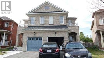 Brampton (Madoc) apartment for rent - A two-story house with a garage and two cars parked in front.