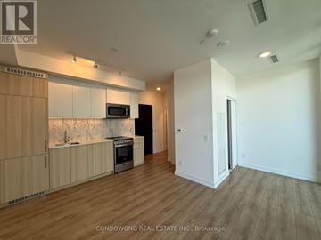 Toronto (Annex) condo for rent - A kitchen with white cabinets and a microwave above the stove.