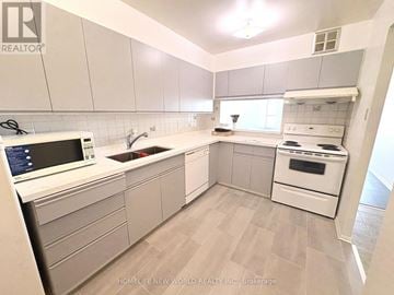 Toronto (Agincourt South-Malvern West) condo for rent - A kitchen with white cabinets and appliances.