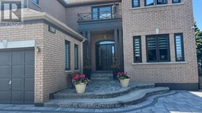 Markham (Milliken Mills East) apartment for rent - A brick house with a black door and windows with flower pots on the steps.