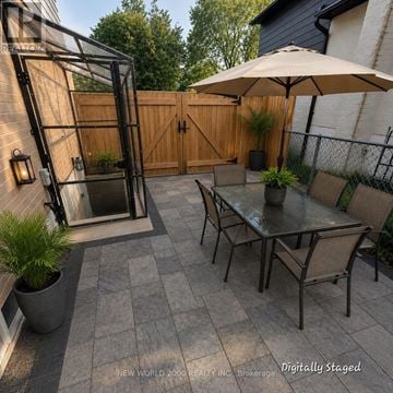 Newmarket (Central Newmarket) apartment for rent - A patio with a table and chairs and a glass door.