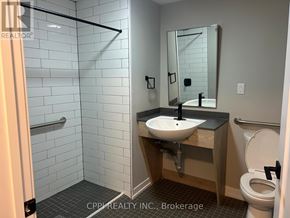 Oshawa (Central) condo for rent - A bathroom with a sink, toilet and a shower.
