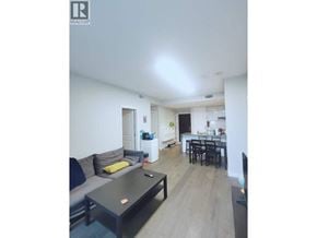 Vancouver apartment for rent - A living room with a grey couch and a black coffee table.
