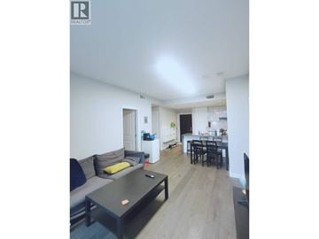Vancouver apartment for rent - A living room with a grey couch and a black coffee table.