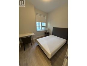 Vancouver townhouse for rent - A bedroom with a bed, desk, and chair.