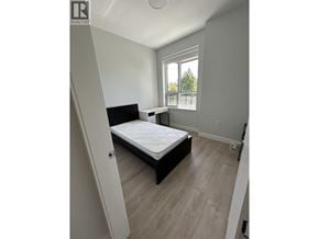 Vancouver townhouse for rent - A bedroom with a bed, nightstand, and window.