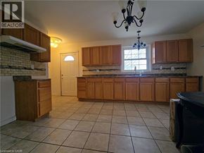 Cambridge apartment for rent - A kitchen with wooden cabinets and a brick wall.
