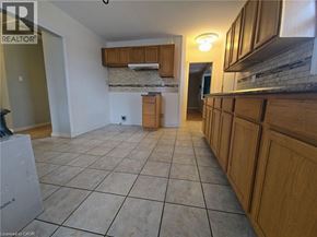 Cambridge apartment for rent - A room with wooden cabinets and a tiled floor.