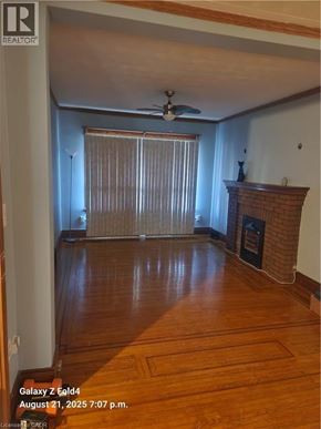 Hamilton apartment for rent - A room with wooden floors and a fireplace is shown.