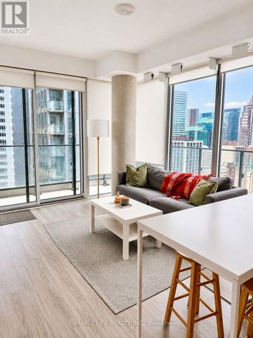 Toronto (Church-Yonge Corridor) condo for rent - A living room with a grey couch and a white coffee table.