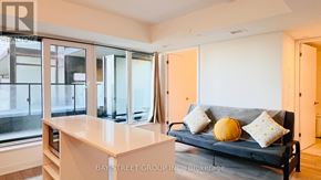 Toronto (Clanton Park) condo for rent - A living room with a couch, a table, and a window.