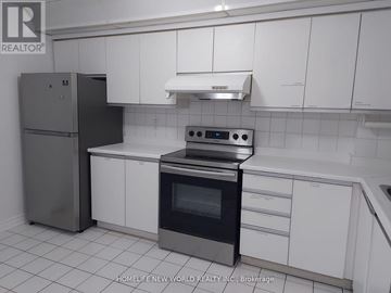 Toronto (Agincourt South-Malvern West) condo for rent - A kitchen with white cabinets and a stainless steel refrigerator.