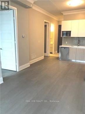 Markham (Unionville) condo for rent - A kitchen area with a microwave, dishwasher, and cabinets.