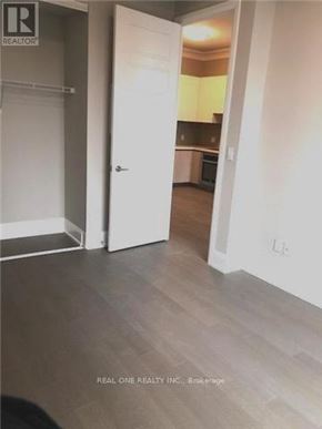 Markham (Unionville) condo for rent - A room with a white door leading to a kitchen.