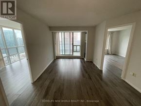 Toronto (Newtonbrook East) condo for rent - A spacious room with wooden flooring and large windows.