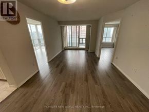 Toronto (Newtonbrook East) condo for rent - A spacious room with wooden flooring and large windows.