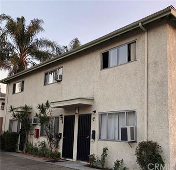 Burbank apartment for rent - A two-story building with a black gate and a red fire hydrant in front.