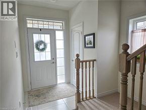 Ancaster townhouse for rent - A white door with a wreath on it is in a hallway.