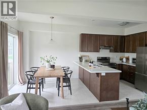 Ancaster townhouse for rent - A modern kitchen with a dining table set for four.