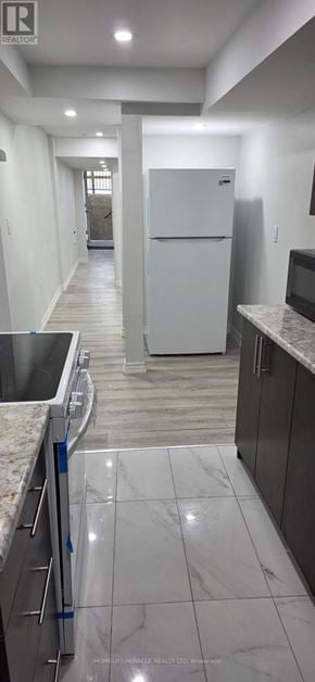Toronto (Rouge) townhouse for rent - A kitchen with a white fridge and a marble floor.