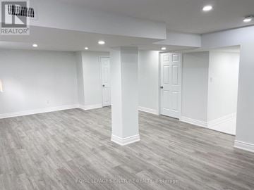 Richmond Hill (Crosby) apartment for rent - A spacious room with grey flooring and white walls.