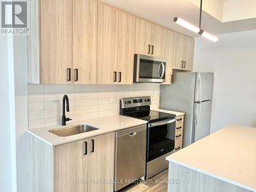 Kitchener townhouse for rent - A kitchen with wooden cabinets and stainless steel appliances.