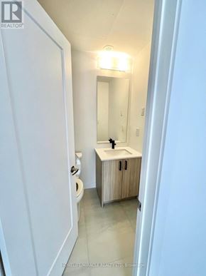 Kitchener townhouse for rent - A bathroom with a sink, toilet and mirror.