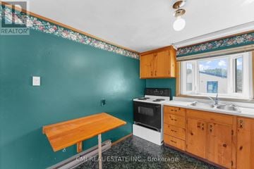 Trent Hills apartment for rent - A kitchen with a table and a stove top oven.