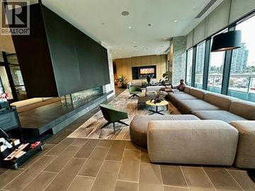 Burnaby apartment for rent - A living room with a large couch and a television.