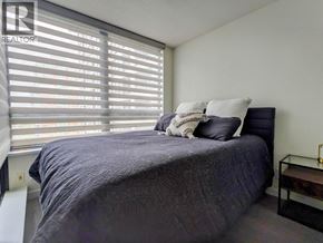 Vancouver apartment for rent - A bedroom with a bed, pillows, and a nightstand.