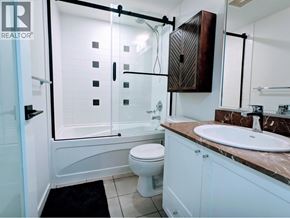 Vancouver apartment for rent - A bathroom with a toilet, sink, and shower.
