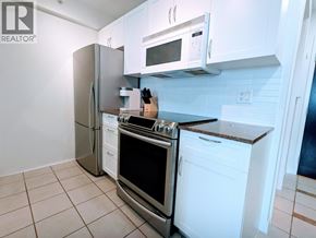 Vancouver apartment for rent - A kitchen with white cabinets and appliances.