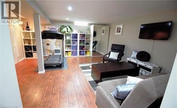 Hamilton apartment for rent - A living room with a grey couch and a black chair.