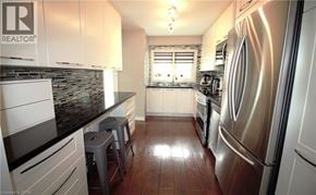 Hamilton apartment for rent - A kitchen with a refrigerator on the right side.