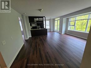 Toronto (Bendale) condo for rent - A room with wooden floors and a large window.