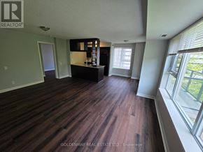 Toronto (Bendale) condo for rent - A room with wooden flooring and a large window on the right side.