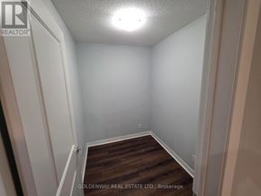 Toronto (Bendale) condo for rent - A small, empty room with white walls and a wooden floor.