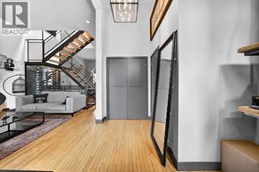 Hamilton apartment for rent - A living room with a staircase and a flat screen TV.
