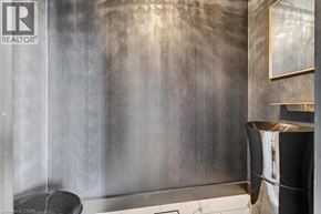 Hamilton apartment for rent - A bathroom with a shower curtain and a trash can.
